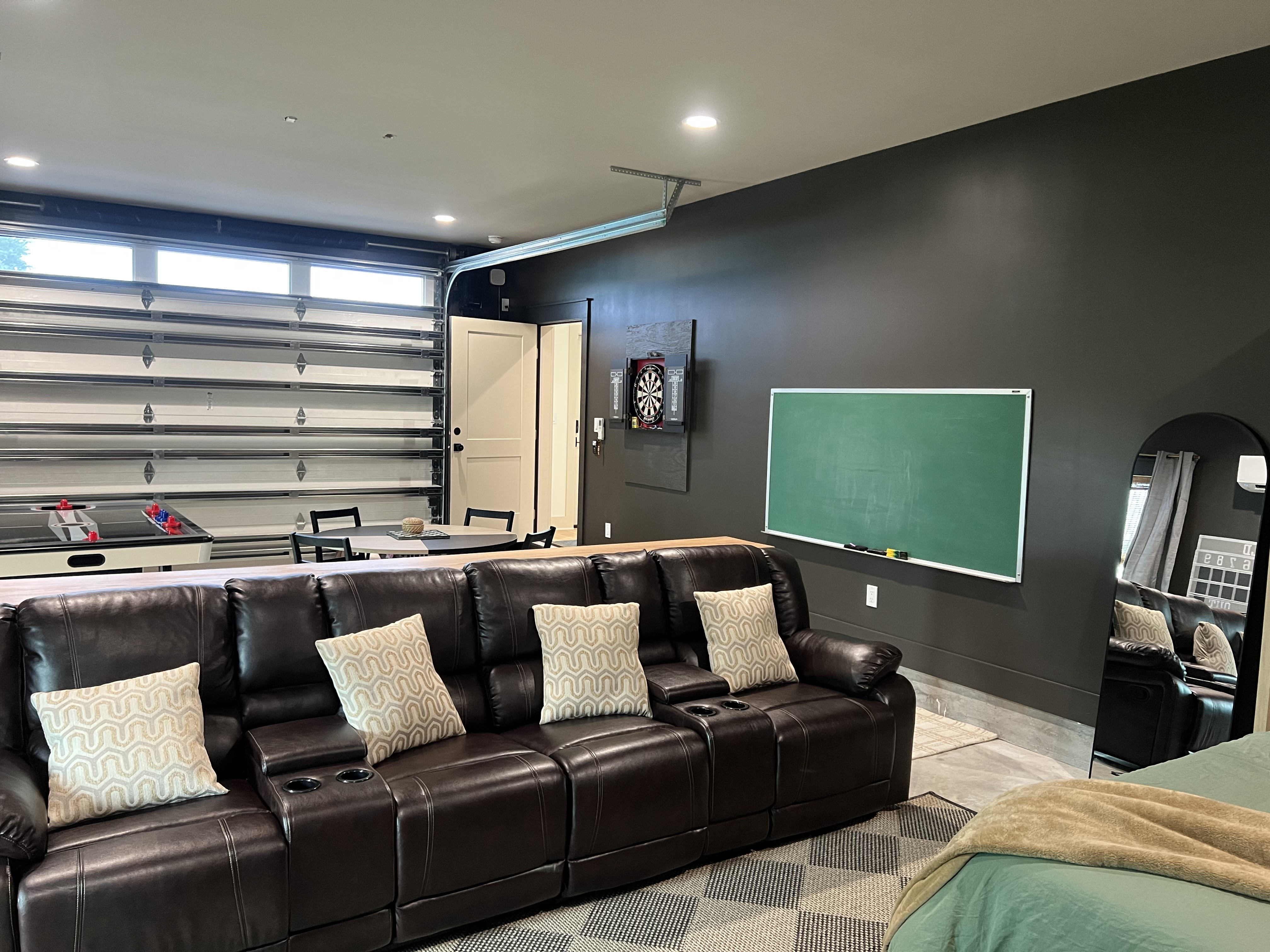 Game room wide view with leather sofa