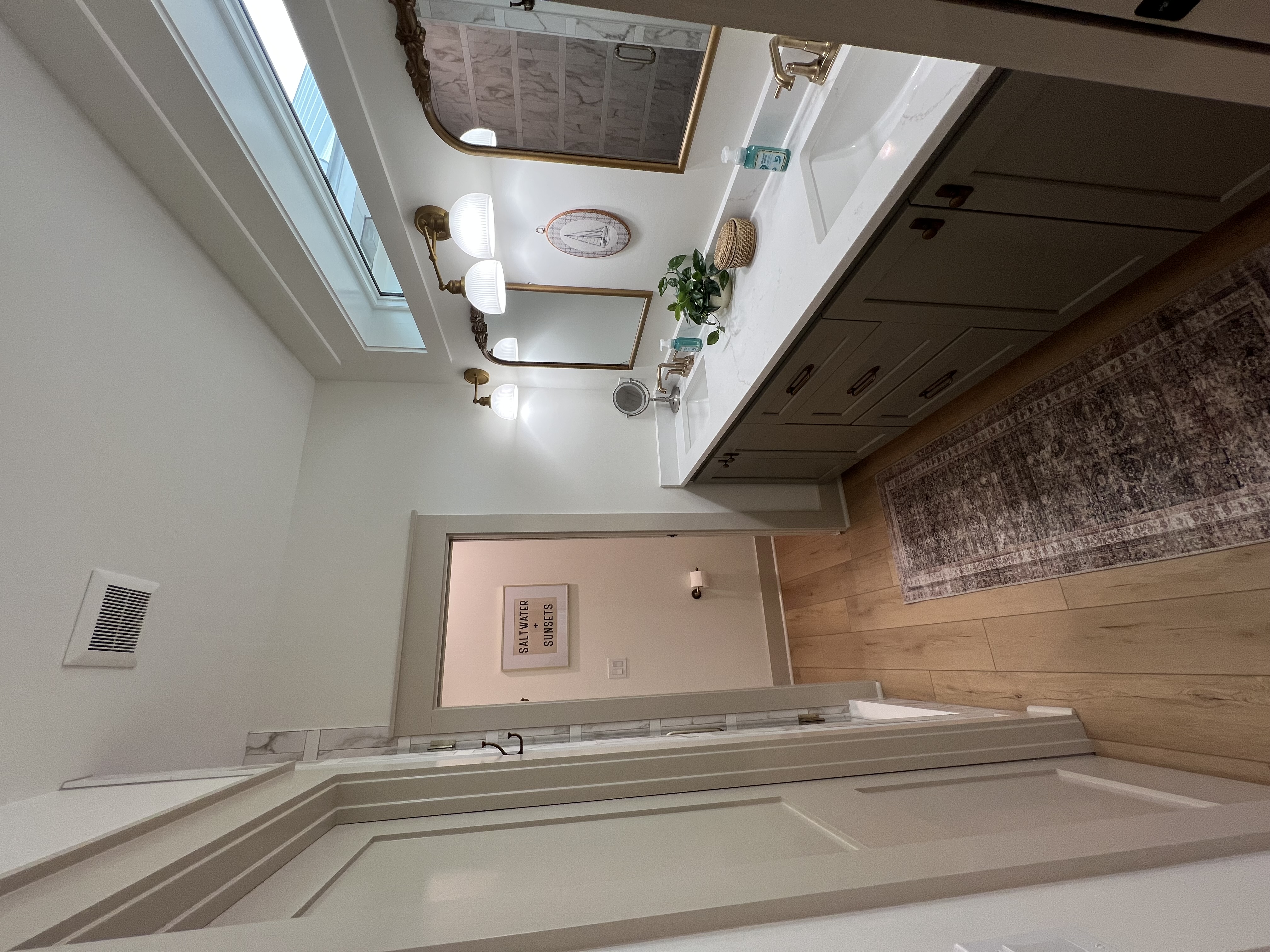 Master bathroom with soaking tub and skylight