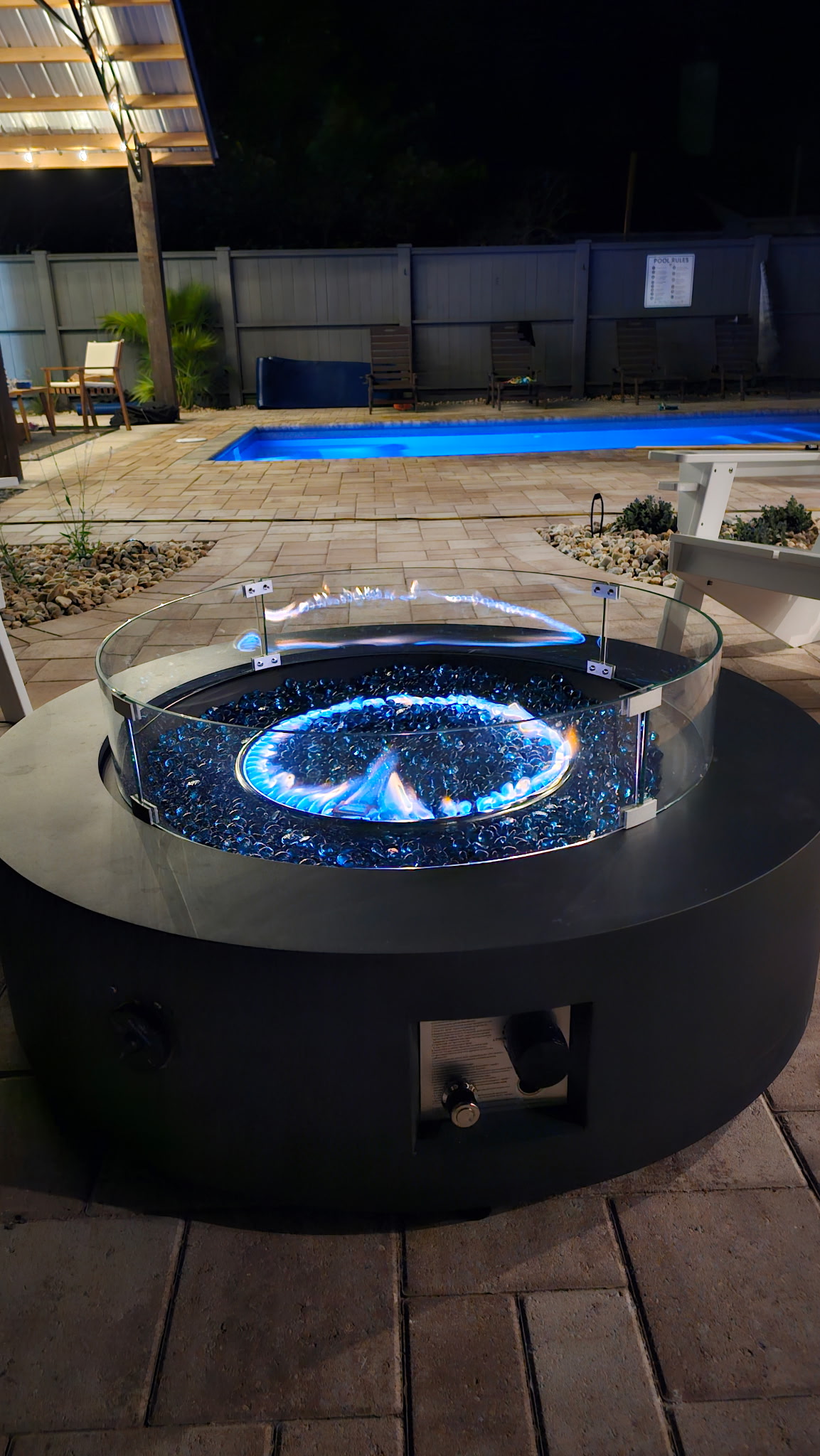 Fire pit and pool lit up at night