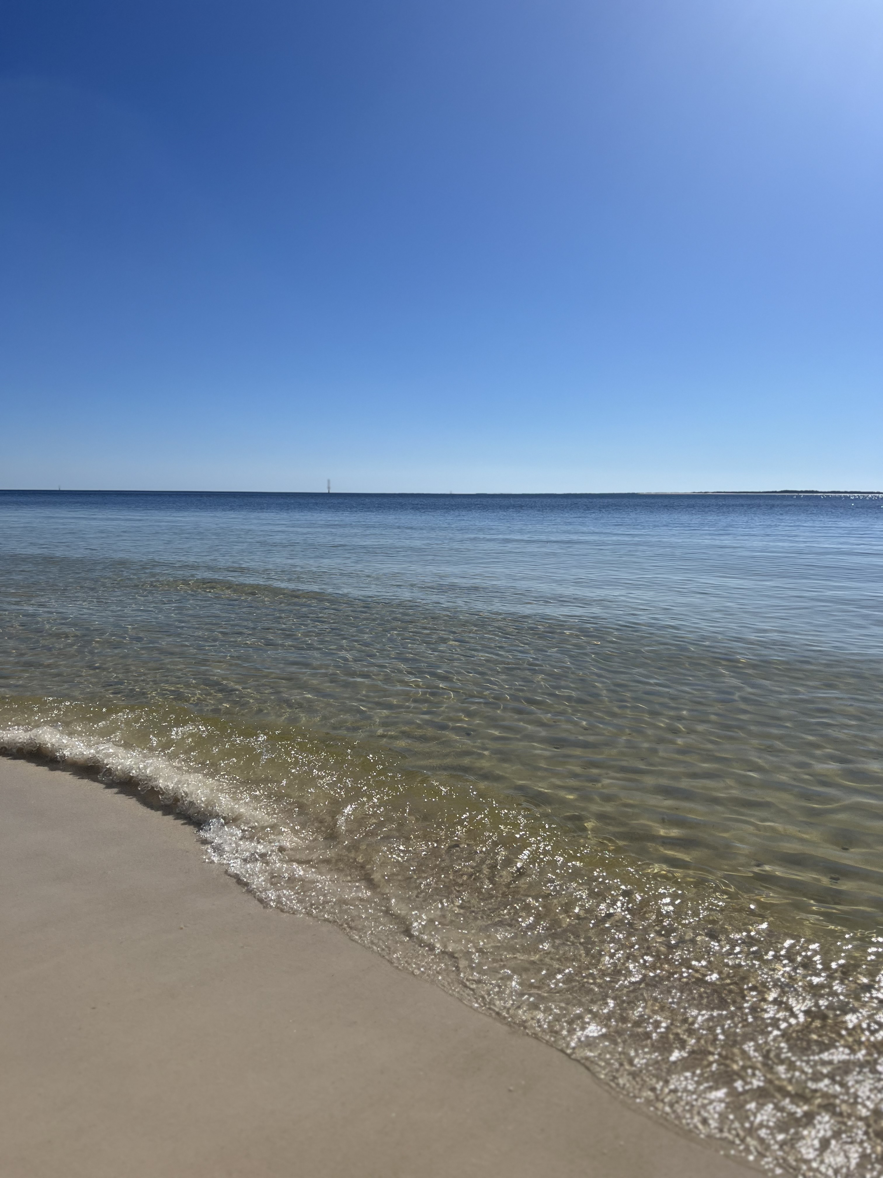 Clear turquoise Gulf water lapping white sand